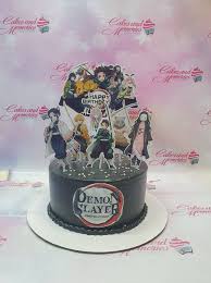 A black 1 tier cake featuring Demon Slayer character printouts, the Demon Slayer logo, a 'Happy Birthday' message, white sprinkles, and a black shell border at the base. A black 1 tier cake featuring Demon Slayer character printouts, the Demon Slayer logo, a 'Happy Birthday' message, white sprinkles, and a black shell border at the base.
