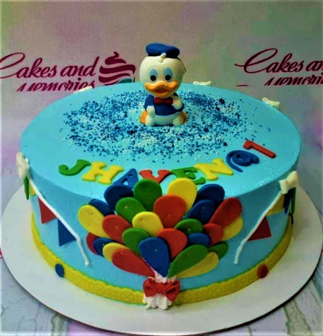 Blue Donald Duck themed birthday cake with colorful fondant balloons and bunting decorations Blue Donald Duck themed birthday cake with colorful fondant balloons and bunting decorations
