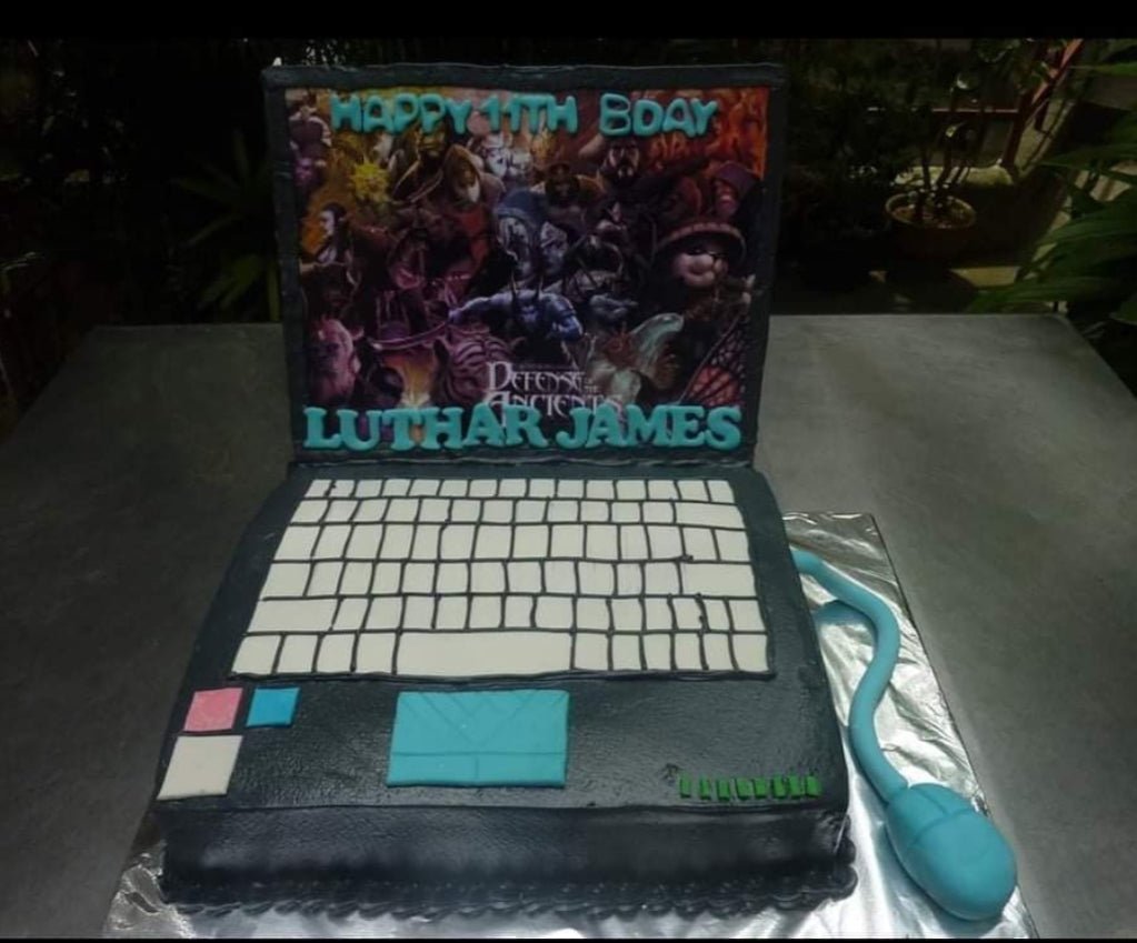 Black laptop-shaped cake with a Defense of the Ancients (DotA) game screen printout and a blue fondant mouse. Black laptop-shaped cake with a Defense of the Ancients (DotA) game screen printout and a blue fondant mouse.