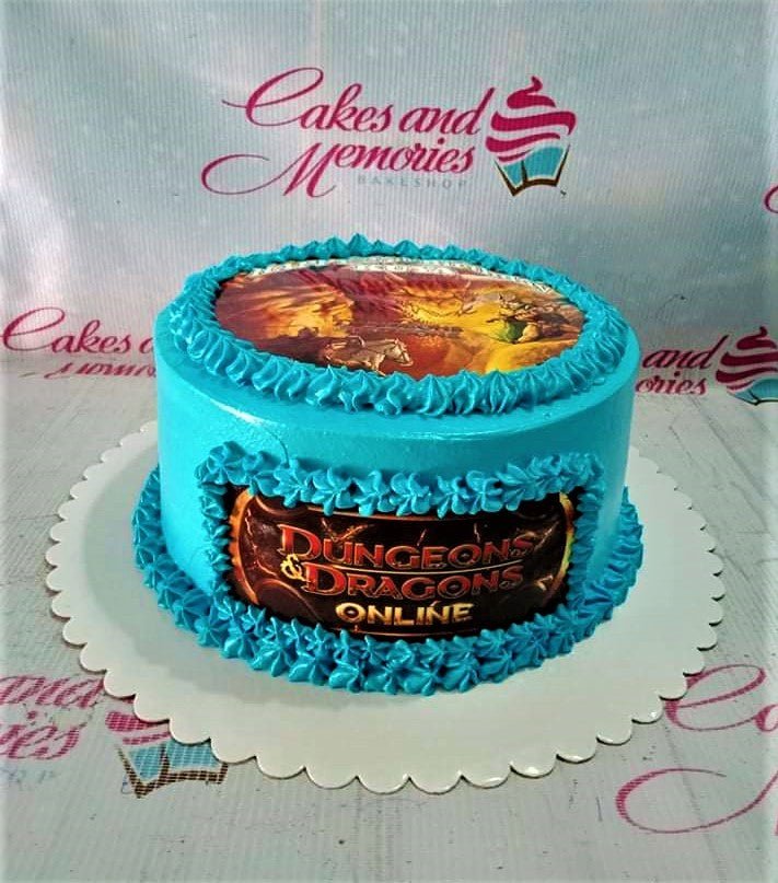 Light blue Dungeons and Dragons Online themed cake with printed game art on top and side, featuring blue icing rosettes. Light blue Dungeons and Dragons Online themed cake with printed game art on top and side, featuring blue icing rosettes.