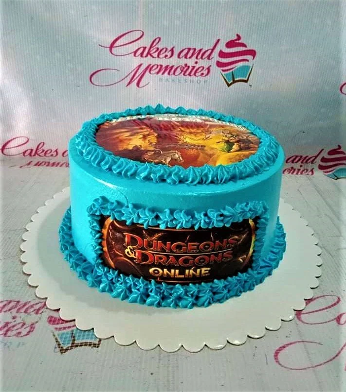 Light blue Dungeons and Dragons Online themed cake with printed game art on top and side, featuring blue icing rosettes.