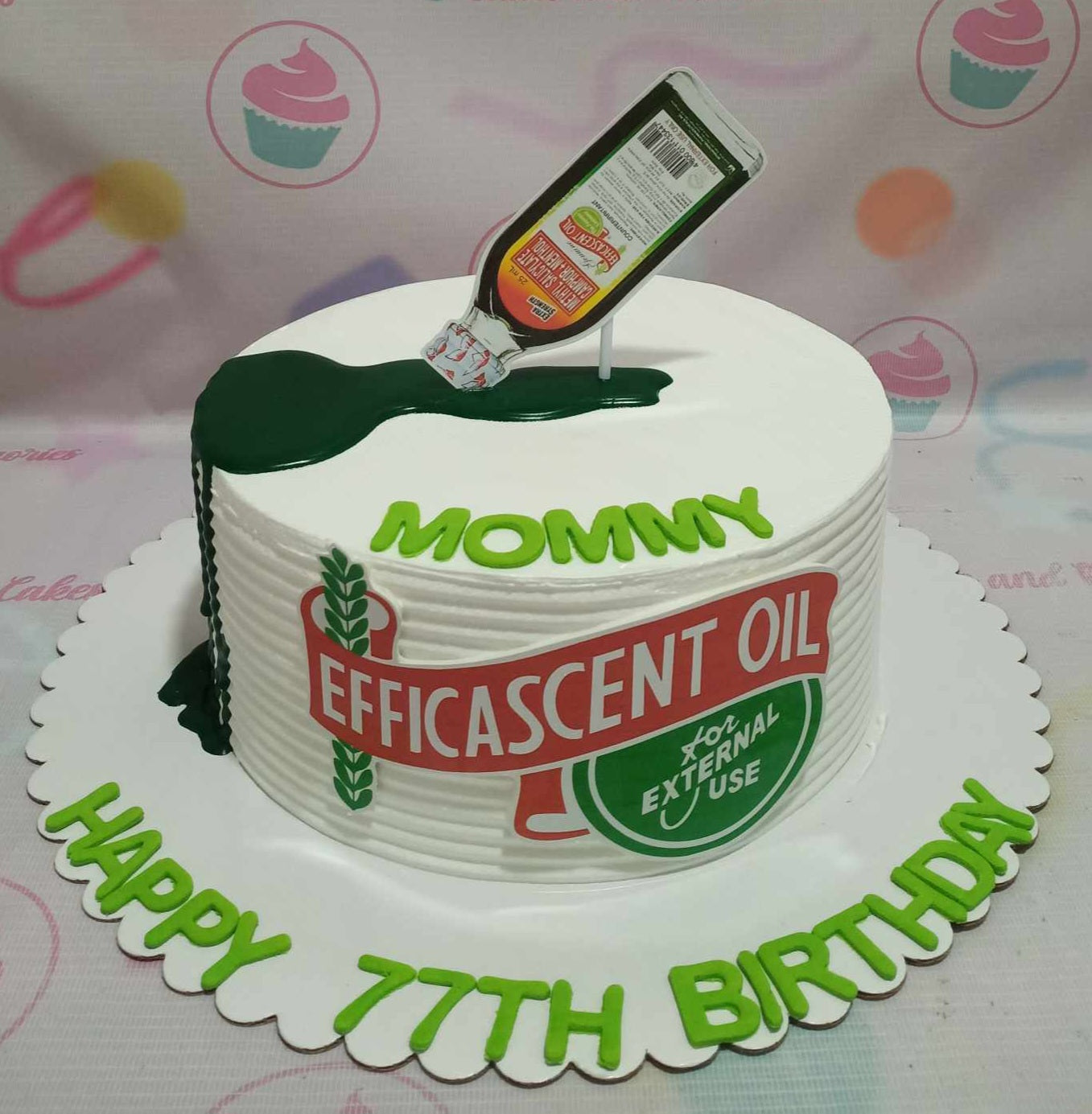 White 1-tier birthday cake featuring an Efficascent Oil theme with a green drip and printed oil bottle topper. White 1-tier birthday cake featuring an Efficascent Oil theme with a green drip and printed oil bottle topper.