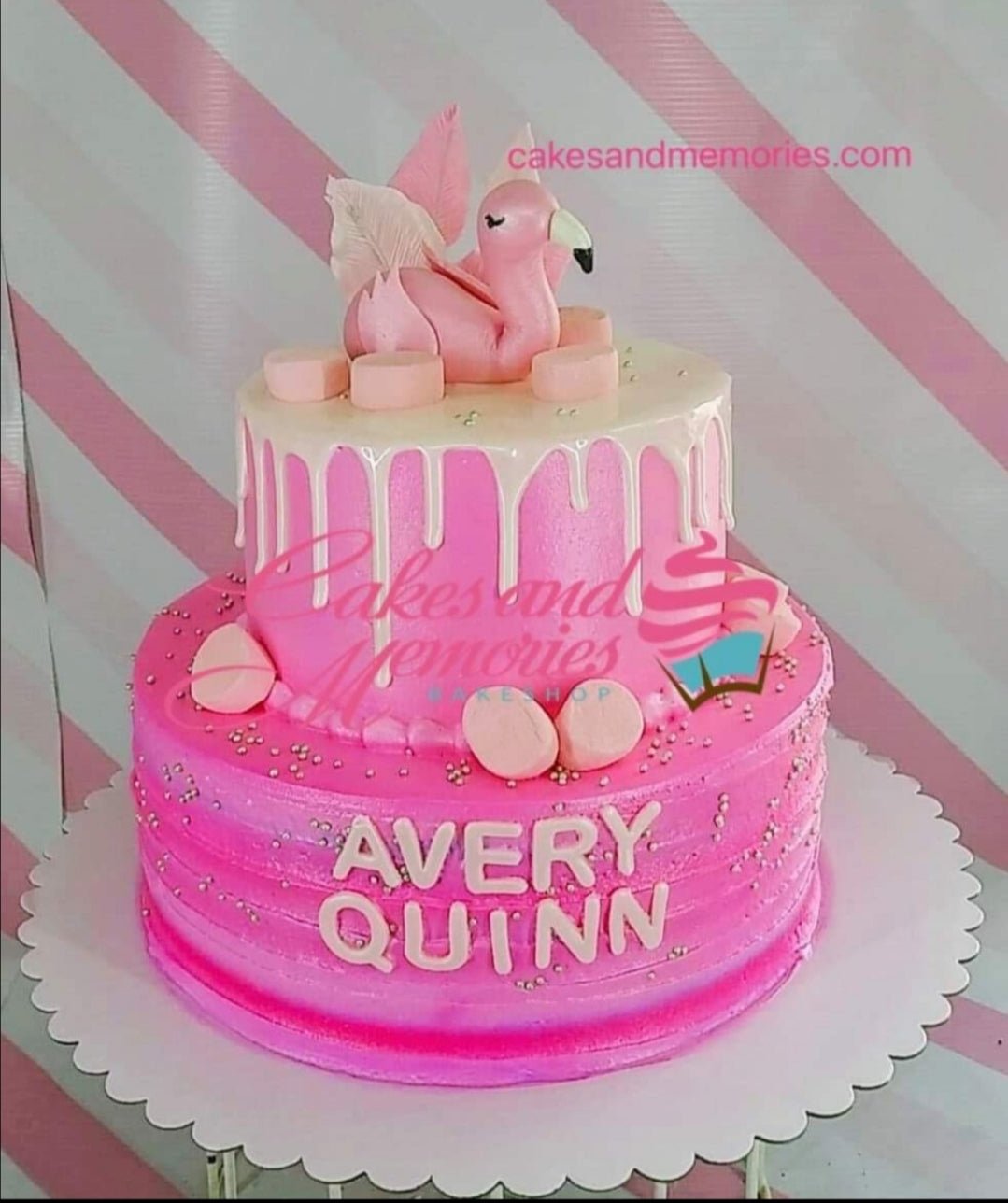 Two-tier pink flamingo birthday cake with white chocolate drip, pink marshmallows, and silver dragees. Two-tier pink flamingo birthday cake with white chocolate drip, pink marshmallows, and silver dragees.