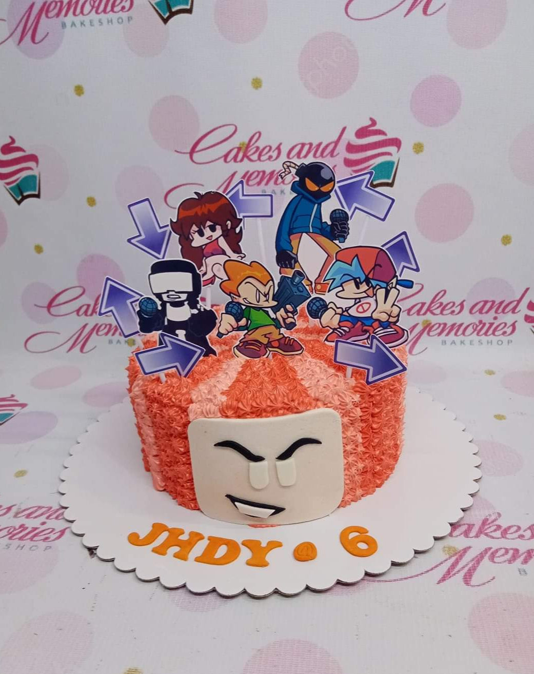 Friday Night Funkin themed birthday cake with orange and peach icing rosettes and character printouts. Friday Night Funkin themed birthday cake with orange and peach icing rosettes and character printouts.