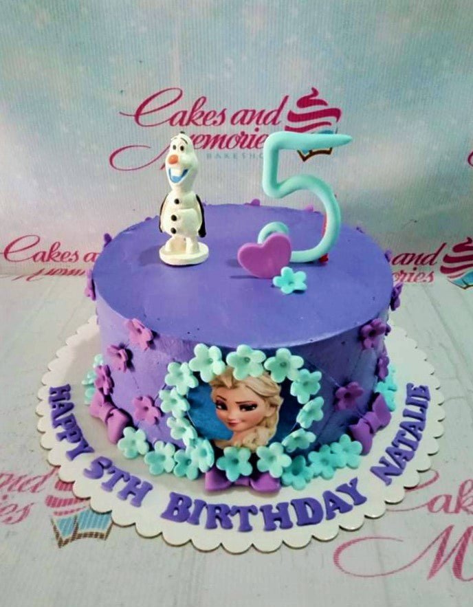 Purple Frozen themed birthday cake with Olaf figurine, Elsa printout, and light blue fondant flowers and number 5 topper. Purple Frozen themed birthday cake with Olaf figurine, Elsa printout, and light blue fondant flowers and number 5 topper.