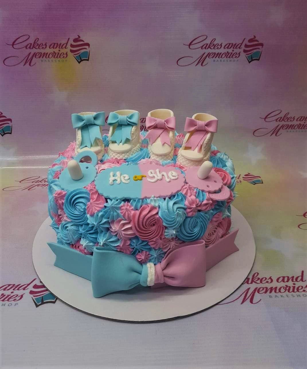 Gender reveal cake with pink and blue icing rosettes, fondant baby shoes, and pacifiers on top. Gender reveal cake with pink and blue icing rosettes, fondant baby shoes, and pacifiers on top.