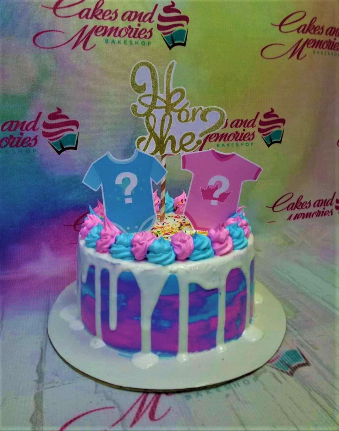 Gender reveal cake with blue and pink icing swirls, white drip, and 'He or She' glitter topper with baby onesie cutouts. Gender reveal cake with blue and pink icing swirls, white drip, and 'He or She' glitter topper with baby onesie cutouts.