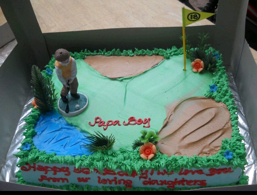 Golf themed rectangle cake with a golfer figurine, sand traps, a water hazard, and a green with an 18th hole flag. Golf themed rectangle cake with a golfer figurine, sand traps, a water hazard, and a green with an 18th hole flag.
