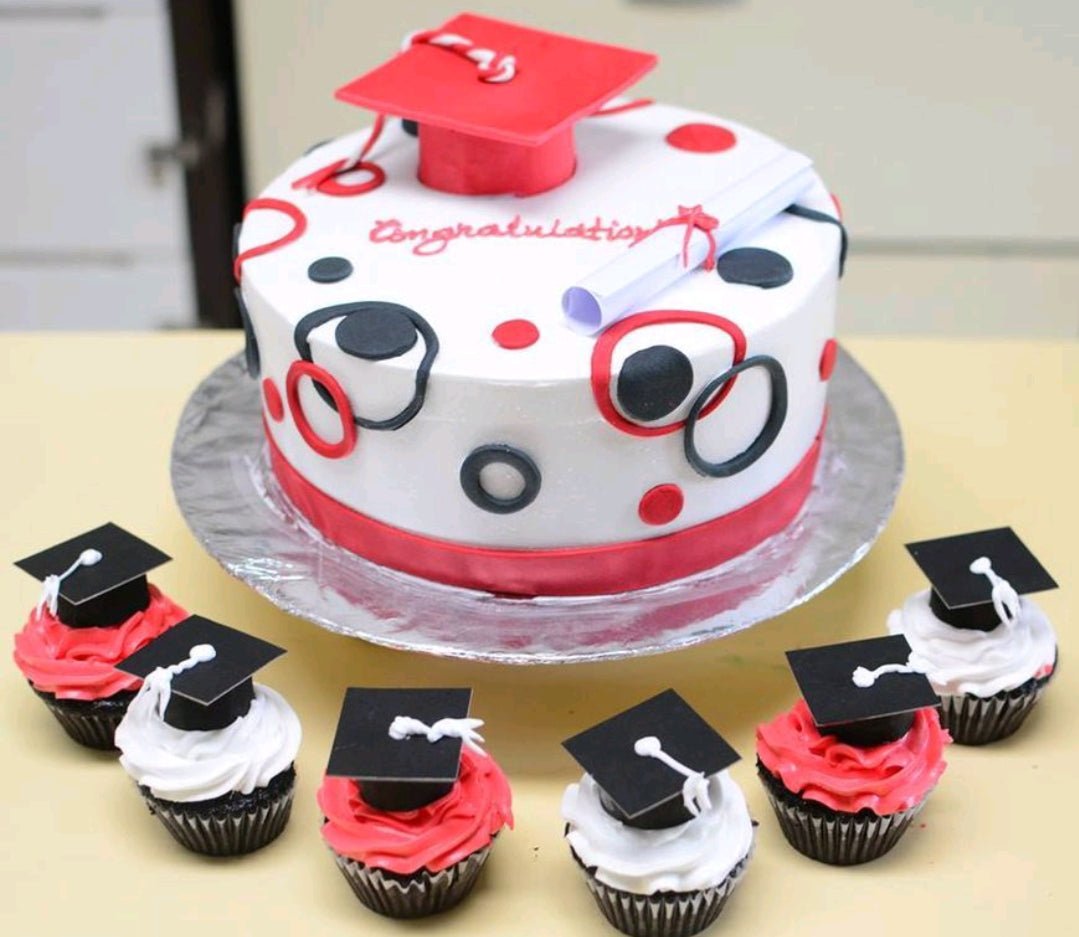 White graduation cake with red and black circle patterns, a red graduation cap topper, and a rolled diploma. White graduation cake with red and black circle patterns, a red graduation cap topper, and a rolled diploma.