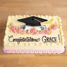Rectangular graduation cake with white icing, pink floral decorations, a black graduation cap topper, and a diploma scroll. Rectangular graduation cake with white icing, pink floral decorations, a black graduation cap topper, and a diploma scroll.