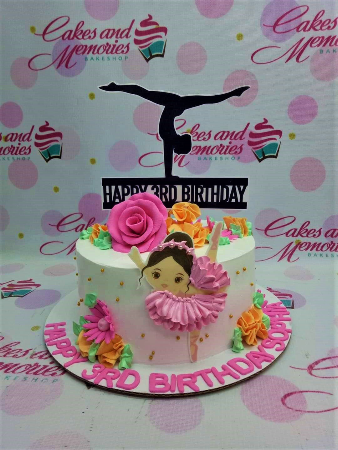 White 1-tier gymnast birthday cake with pink and orange icing flowers and a black gymnast silhouette topper. White 1-tier gymnast birthday cake with pink and orange icing flowers and a black gymnast silhouette topper.