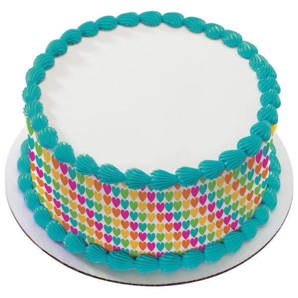 White round cake with teal shell borders and a colorful heart pattern wrap around the sides. White round cake with teal shell borders and a colorful heart pattern wrap around the sides.