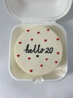 White bento cake with red icing hearts and black piped text saying hello 20 White bento cake with red icing hearts and black piped text saying hello 20