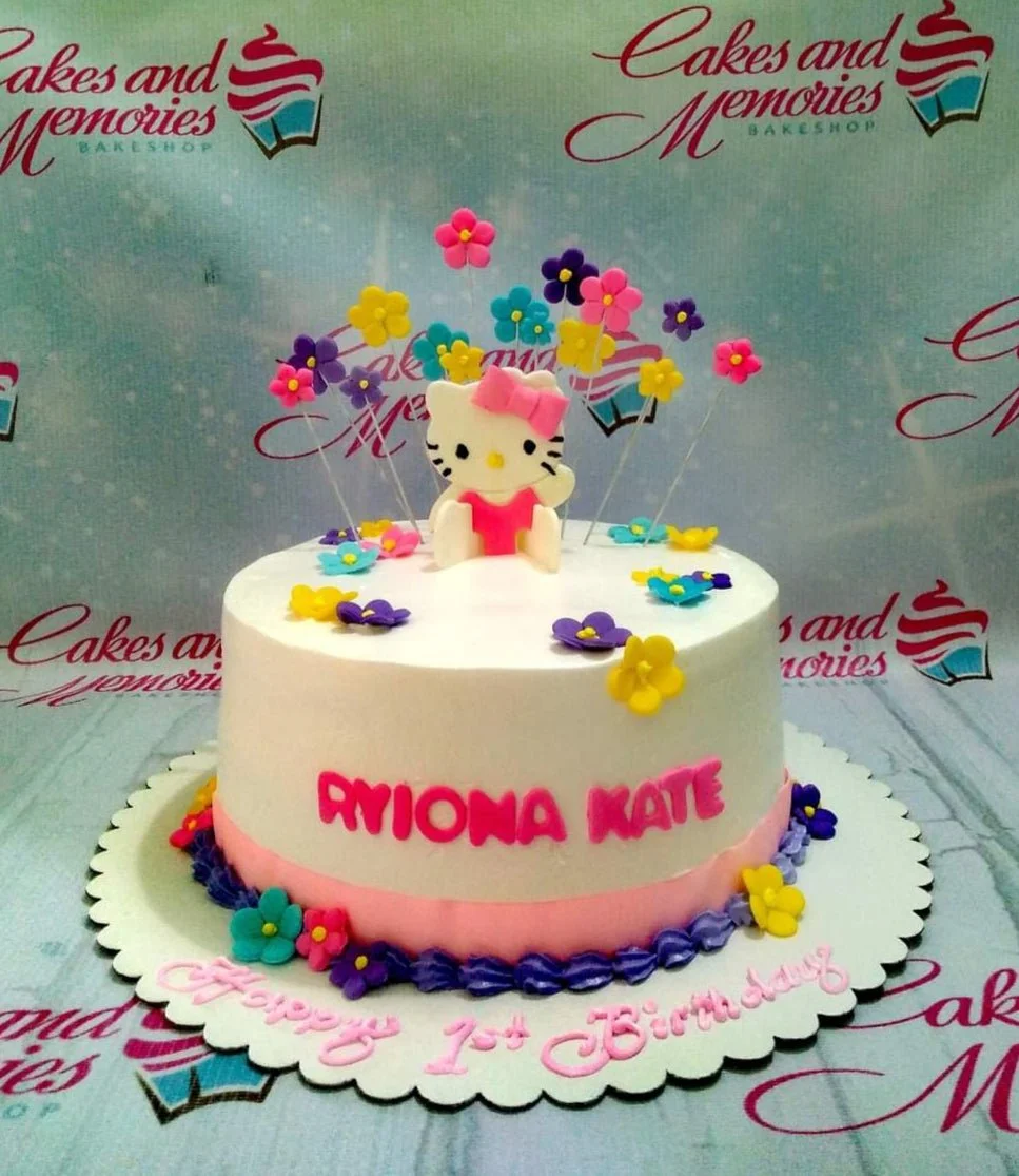 White 1-tier Hello Kitty birthday cake with colorful fondant flowers and pink icing border