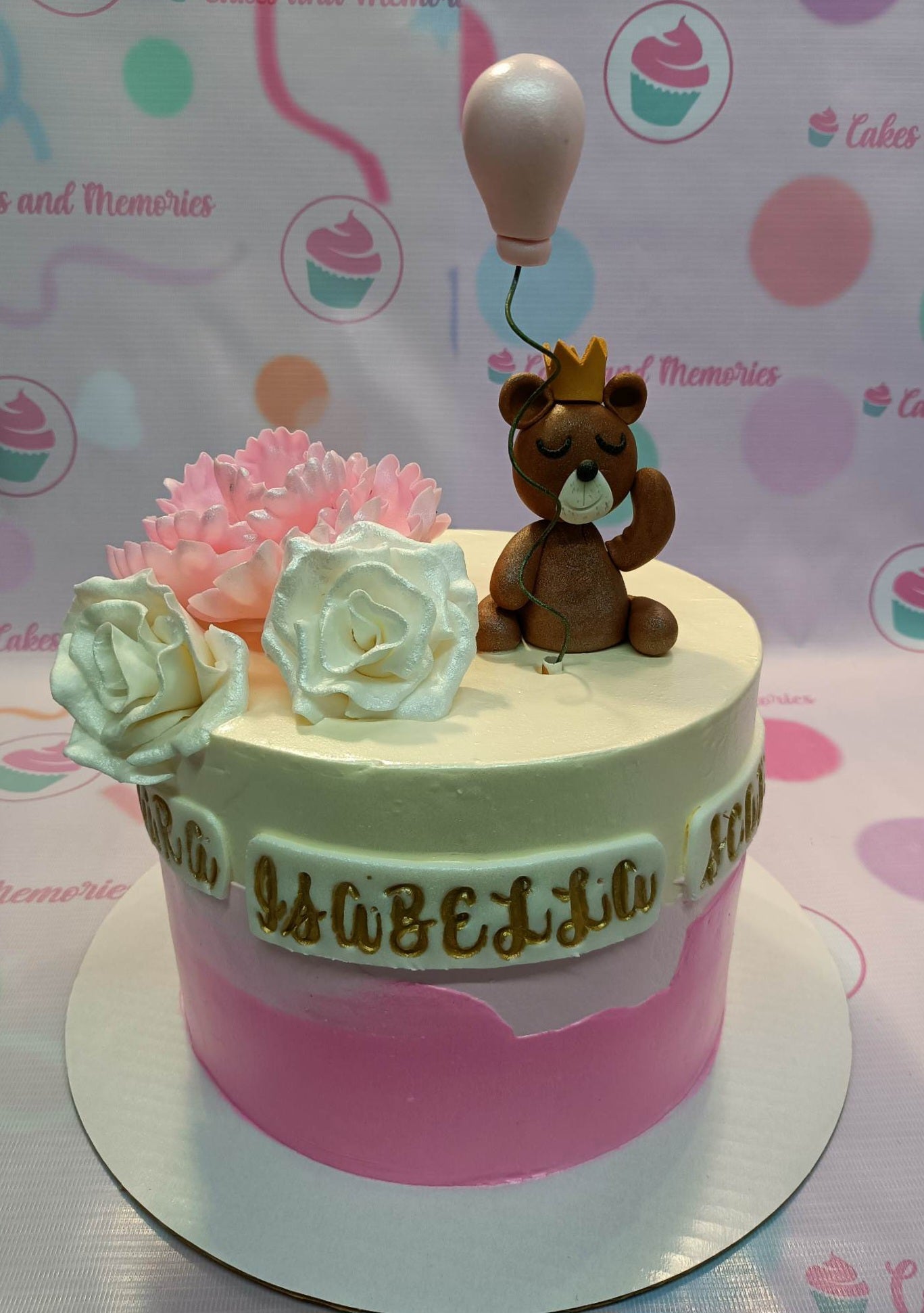 Pink and white ombre cake with a brown fondant bear topper holding a pink balloon and large edible roses. Pink and white ombre cake with a brown fondant bear topper holding a pink balloon and large edible roses.
