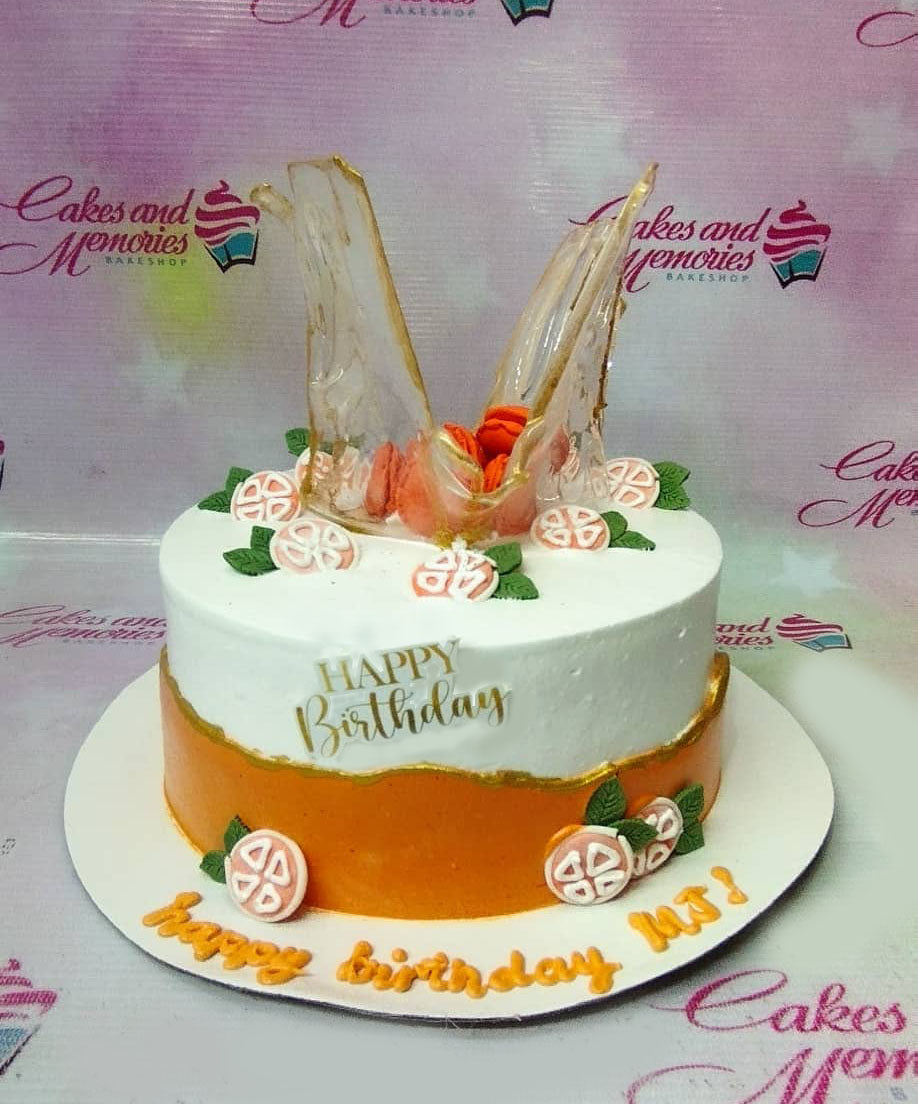 White and orange birthday cake with isomalt sugar glass shards, macarons, and gumpaste leaves. White and orange birthday cake with isomalt sugar glass shards, macarons, and gumpaste leaves.