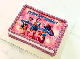 Rectangle birthday cake with a large edible photo print of a K-pop girl group and purple icing borders.