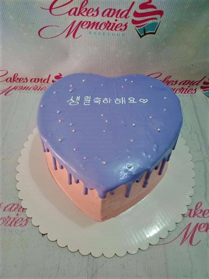 Heart-shaped purple minimalist cake with pink sides, purple drip, silver dragees, and a Korean birthday message.