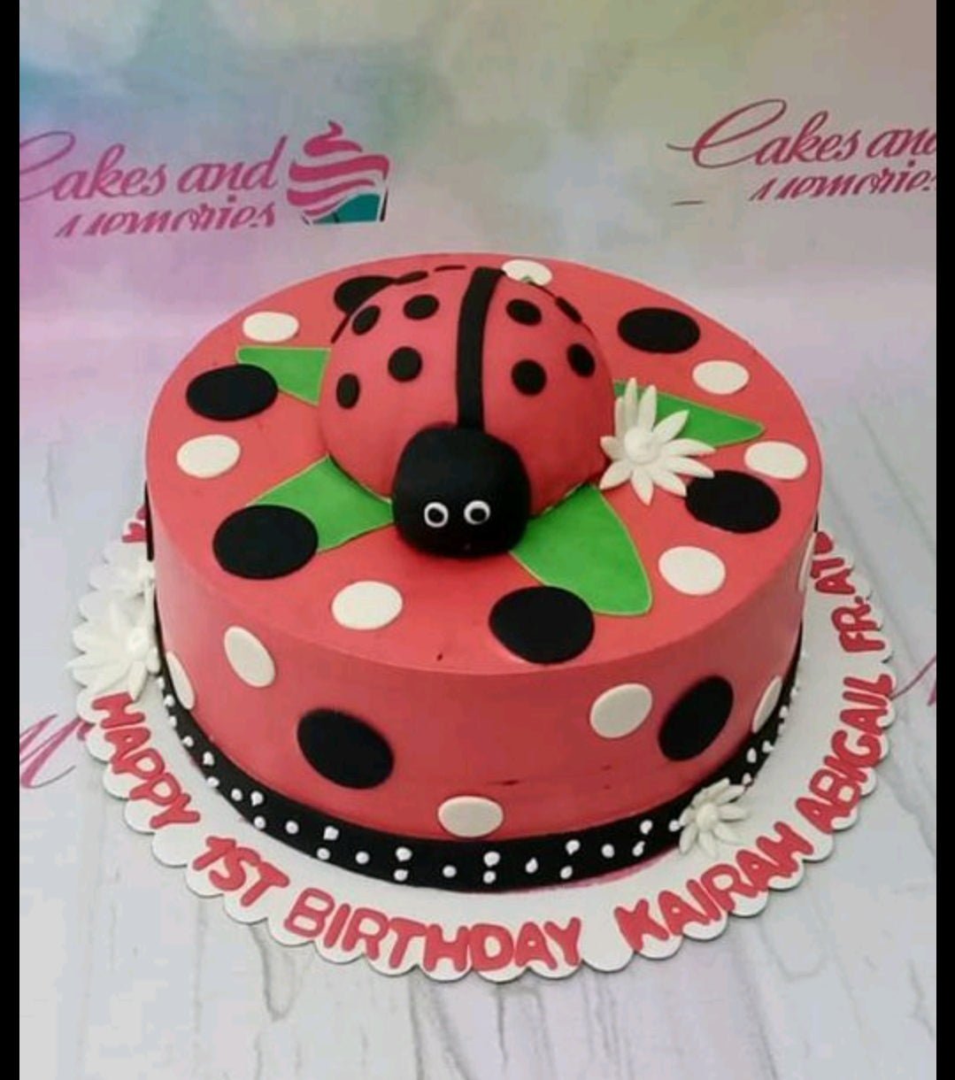 Red ladybug themed birthday cake with black and white polka dots and a large 3D fondant ladybug topper. Red ladybug themed birthday cake with black and white polka dots and a large 3D fondant ladybug topper.