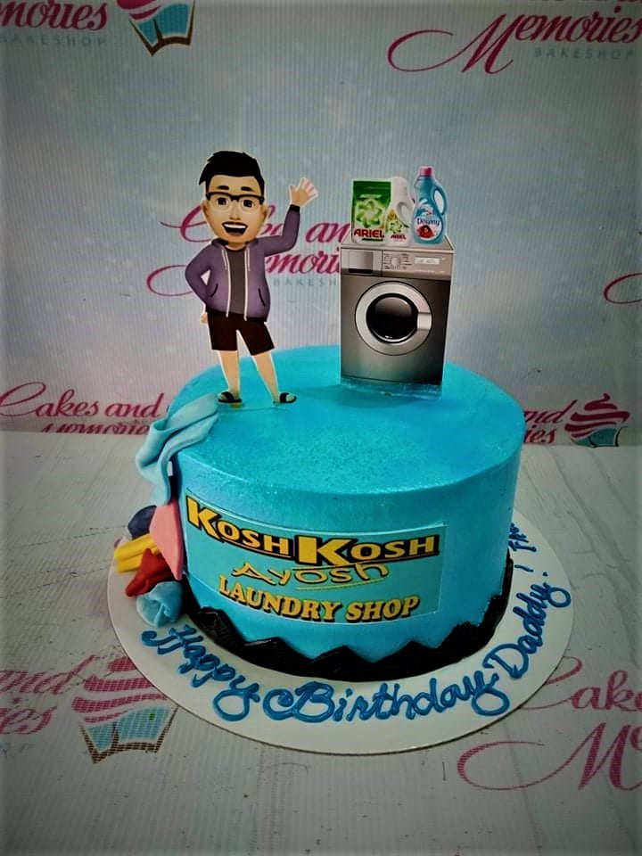 Light blue laundry shop themed birthday cake with a 3D character printout, washing machine, and laundry detergent toppers. Light blue laundry shop themed birthday cake with a 3D character printout, washing machine, and laundry detergent toppers.