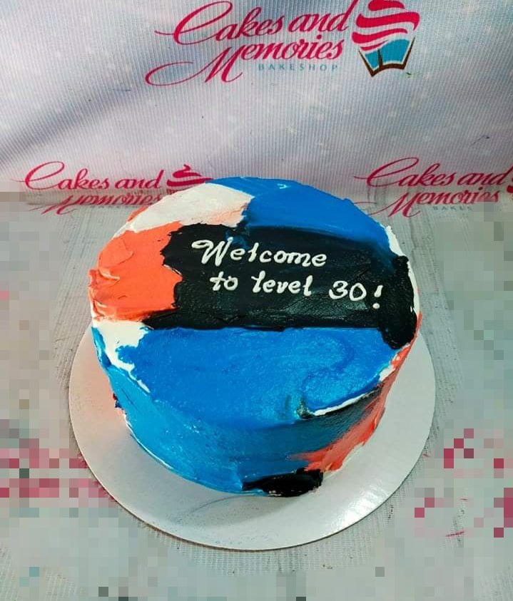 Bento cake with abstract palette knife icing in blue, orange, and black with a 'Welcome to level 30!' message.