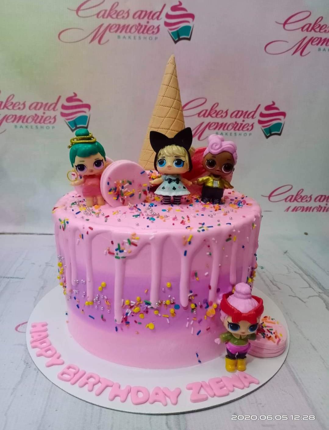 Pink and purple gradient LOL Surprise themed cake with a waffle cone topper and character figurines. Pink and purple gradient LOL Surprise themed cake with a waffle cone topper and character figurines.