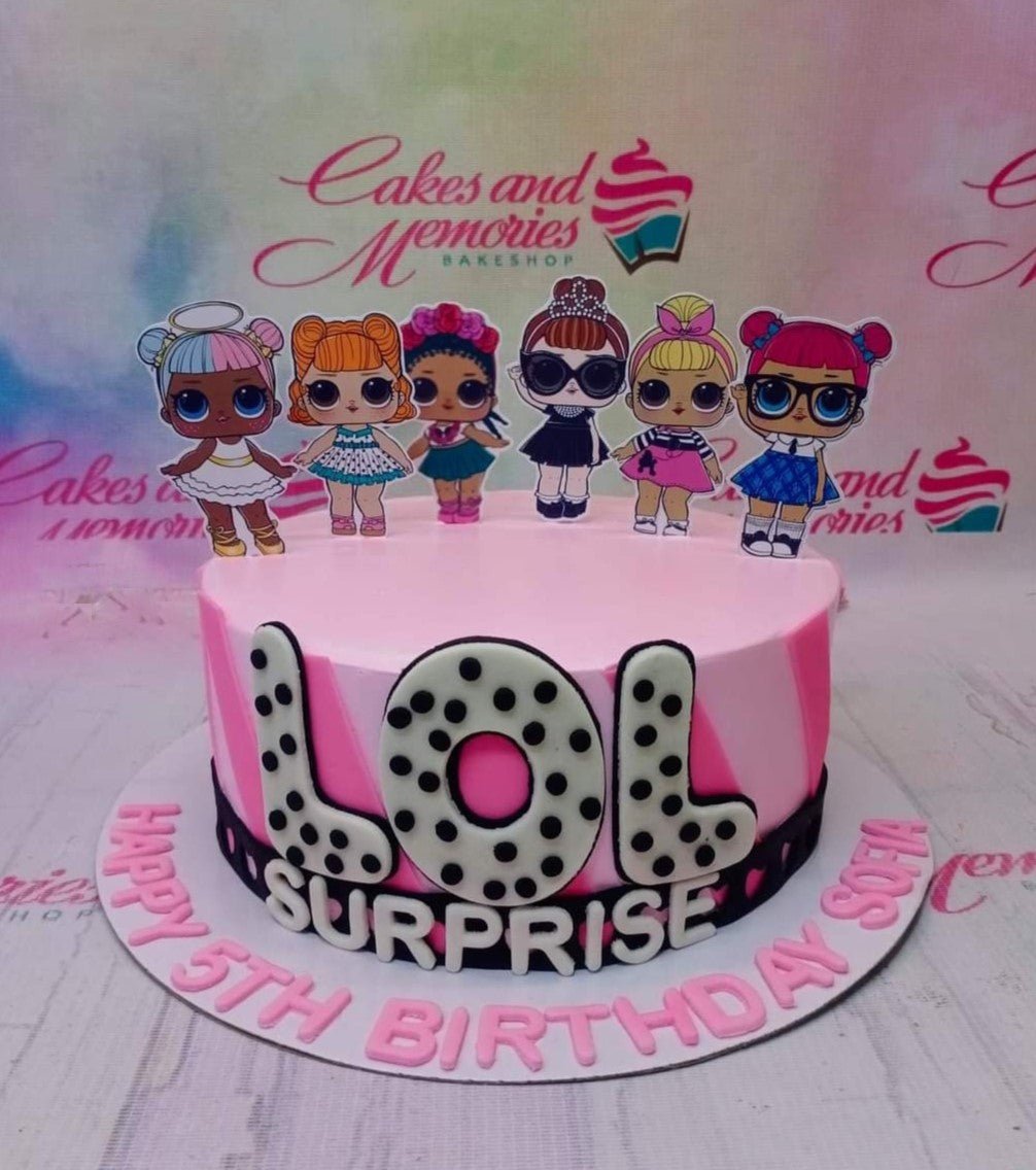 Pink LOL Surprise themed birthday cake with character printouts and large polka dot letters on the side. Pink LOL Surprise themed birthday cake with character printouts and large polka dot letters on the side.