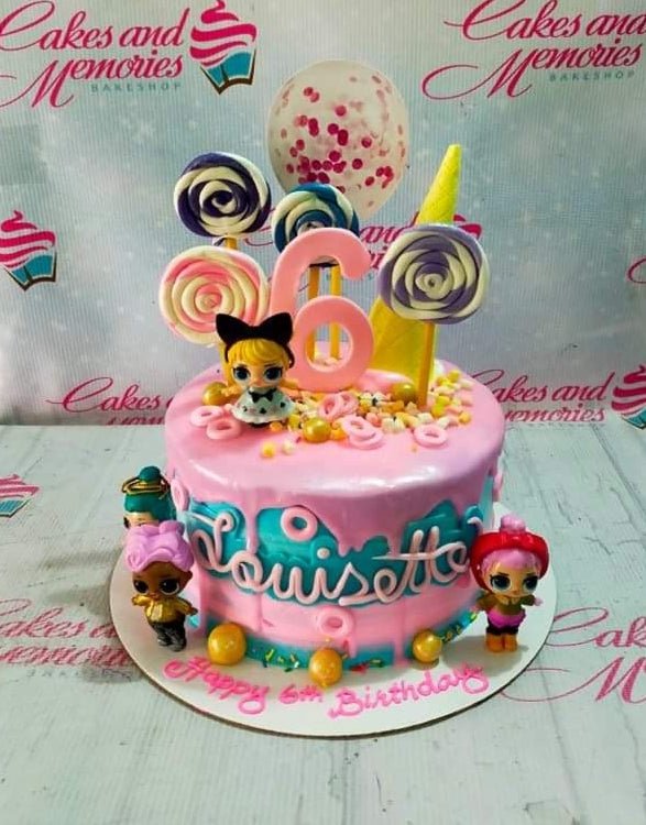 Pink and blue LOL Surprise themed birthday cake with lollipops, a large number 6, and character figurines. Pink and blue LOL Surprise themed birthday cake with lollipops, a large number 6, and character figurines.