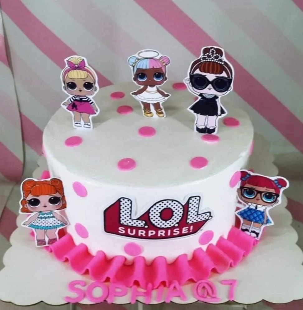 White 1-tier LOL Surprise themed cake with pink polka dots, pink ruffles, and character printouts.