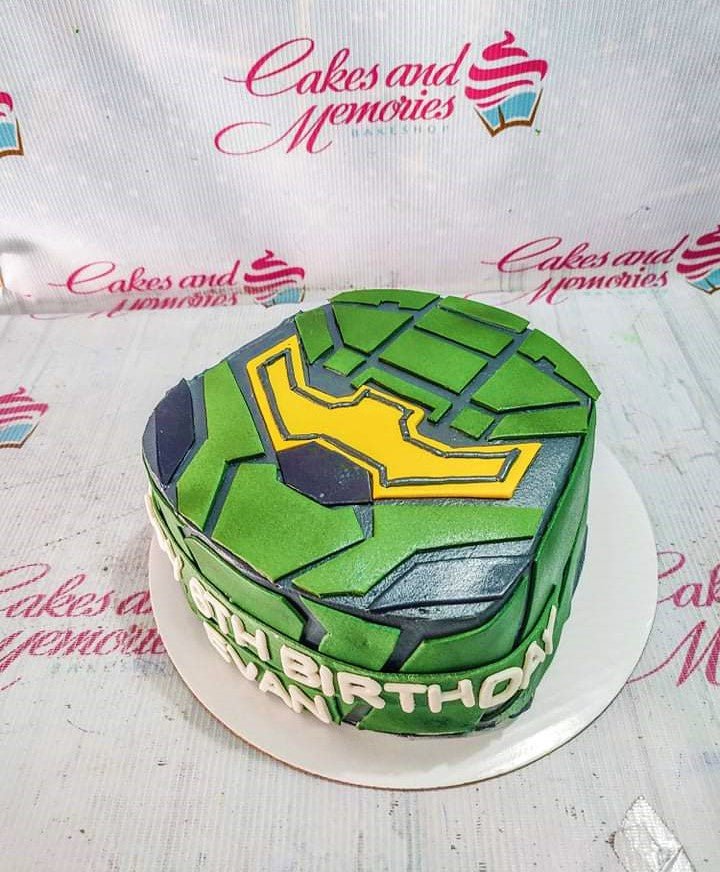 Green and black Master Chief Halo helmet inspired fondant cake with yellow visor and white gumpaste birthday message. Green and black Master Chief Halo helmet inspired fondant cake with yellow visor and white gumpaste birthday message.