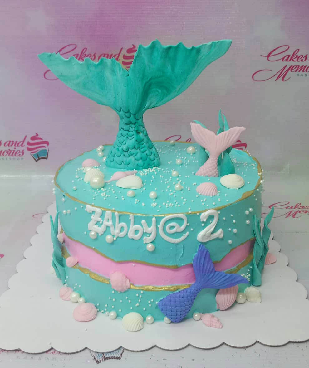 Teal and pink mermaid themed birthday cake with large gumpaste mermaid tail, shells, and pearls for Abby's 2nd birthday. Teal and pink mermaid themed birthday cake with large gumpaste mermaid tail, shells, and pearls for Abby's 2nd birthday.