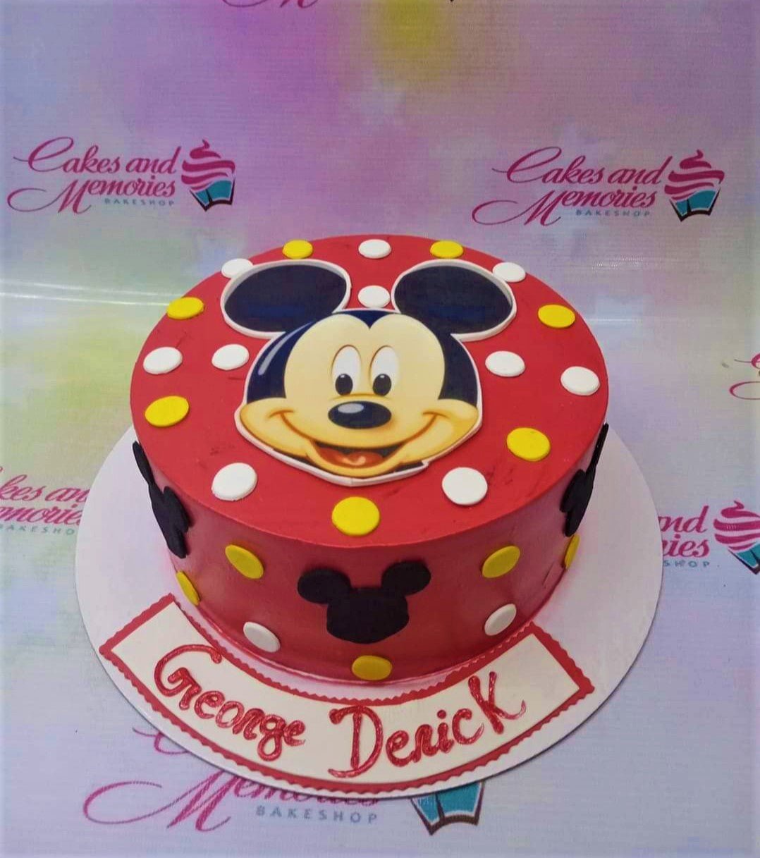 Red Mickey Mouse themed birthday cake with yellow and white polka dots and black Mickey silhouettes. Red Mickey Mouse themed birthday cake with yellow and white polka dots and black Mickey silhouettes.
