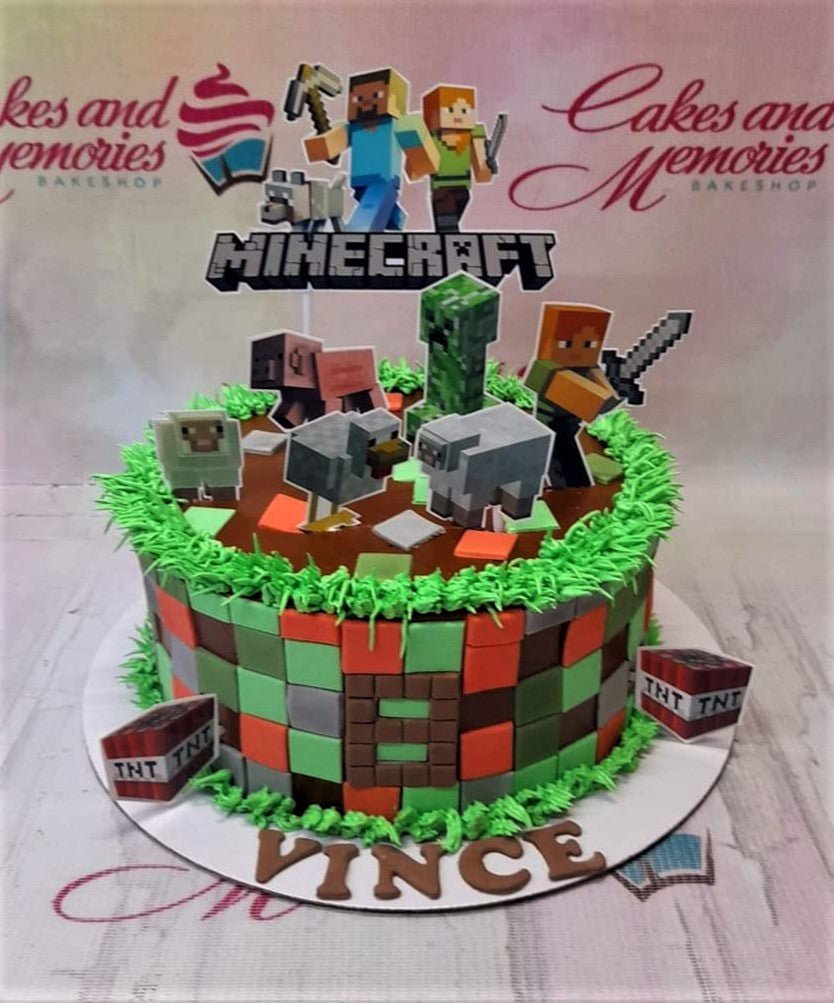 Minecraft themed birthday cake with green grass icing, pixelated block sides, and character printouts including Steve, Alex, and a Creeper. Minecraft themed birthday cake with green grass icing, pixelated block sides, and character printouts including Steve, Alex, and a Creeper.