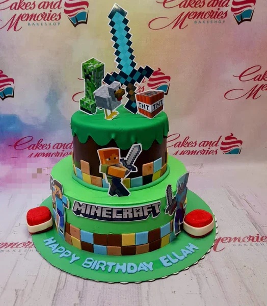 A multicolor 2-tier fondant cake featuring Minecraft characters, TNT blocks, and pixel square decorations.