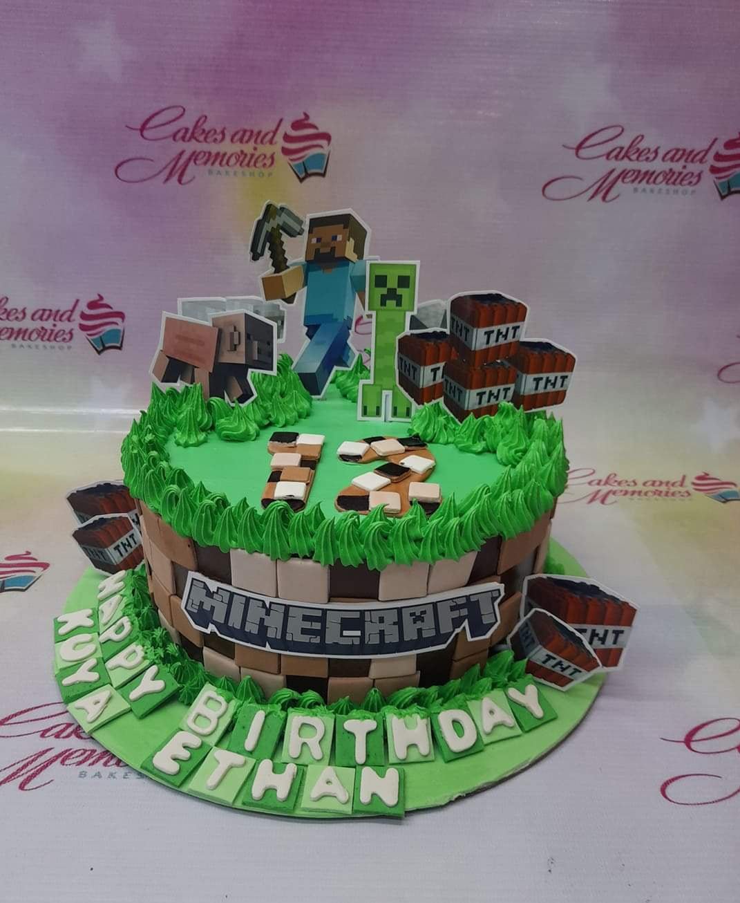 Minecraft themed birthday cake with green grass icing, TNT blocks, Steve, and Creeper toppers for Ethan's 12th birthday. Minecraft themed birthday cake with green grass icing, TNT blocks, Steve, and Creeper toppers for Ethan's 12th birthday.