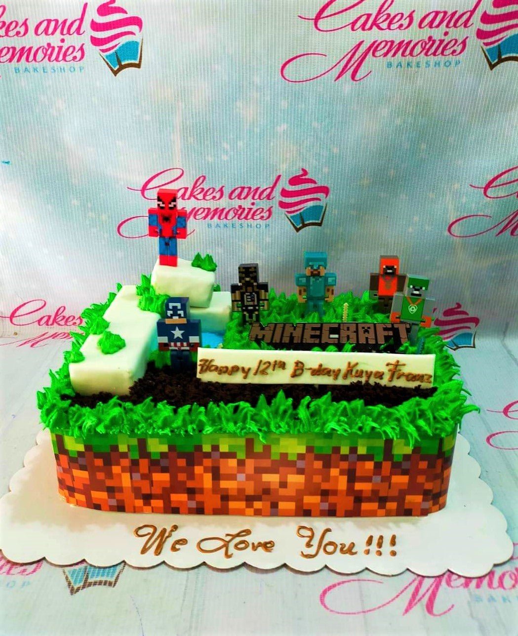 Minecraft themed rectangle cake with green grass icing, pixelated dirt side wrap, and various character toy toppers. Minecraft themed rectangle cake with green grass icing, pixelated dirt side wrap, and various character toy toppers.