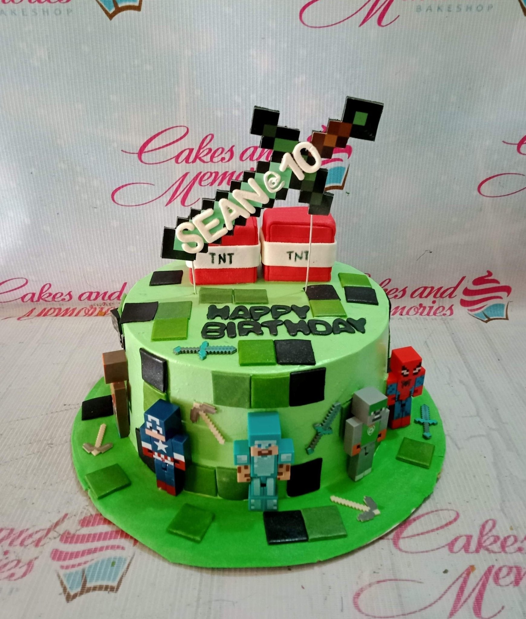Minecraft themed green birthday cake with pixelated characters, TNT blocks, and a pixel sword topper for Sean's 10th birthday. Minecraft themed green birthday cake with pixelated characters, TNT blocks, and a pixel sword topper for Sean's 10th birthday.