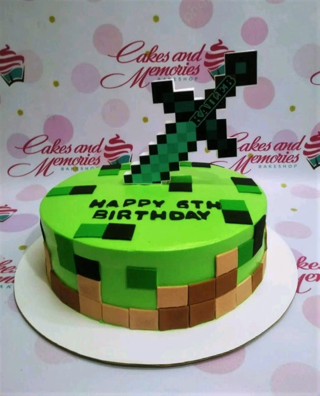 Minecraft-Inspired Mint Birthday Cake A green 1 Tier cake themed around Minecraft, featuring a pixelated sword printout and square fondant accents with a 'HAPPY 6TH BIRTHDAY' message.