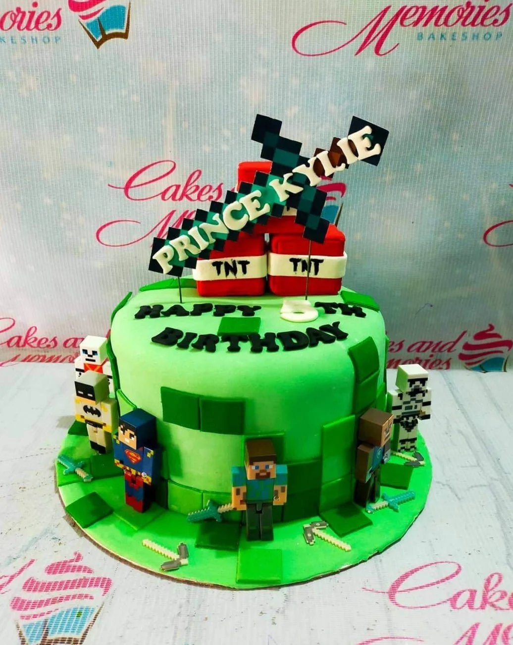 Minecraft-Inspired Mint Birthday Cake A green 1-tier fondant cake themed Minecraft, featuring Steve, Superman, Stormtrooper, TNT, and pixelated accents.