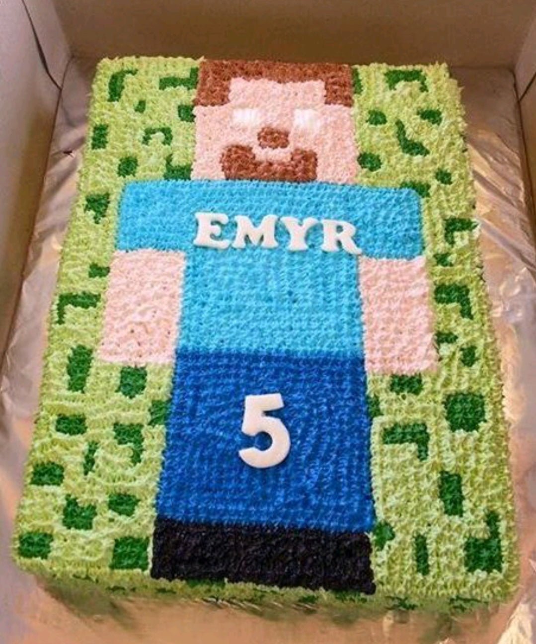 Minecraft Steve character cake with green pixelated icing and white fondant name Emyr and number 5 Minecraft Steve character cake with green pixelated icing and white fondant name Emyr and number 5