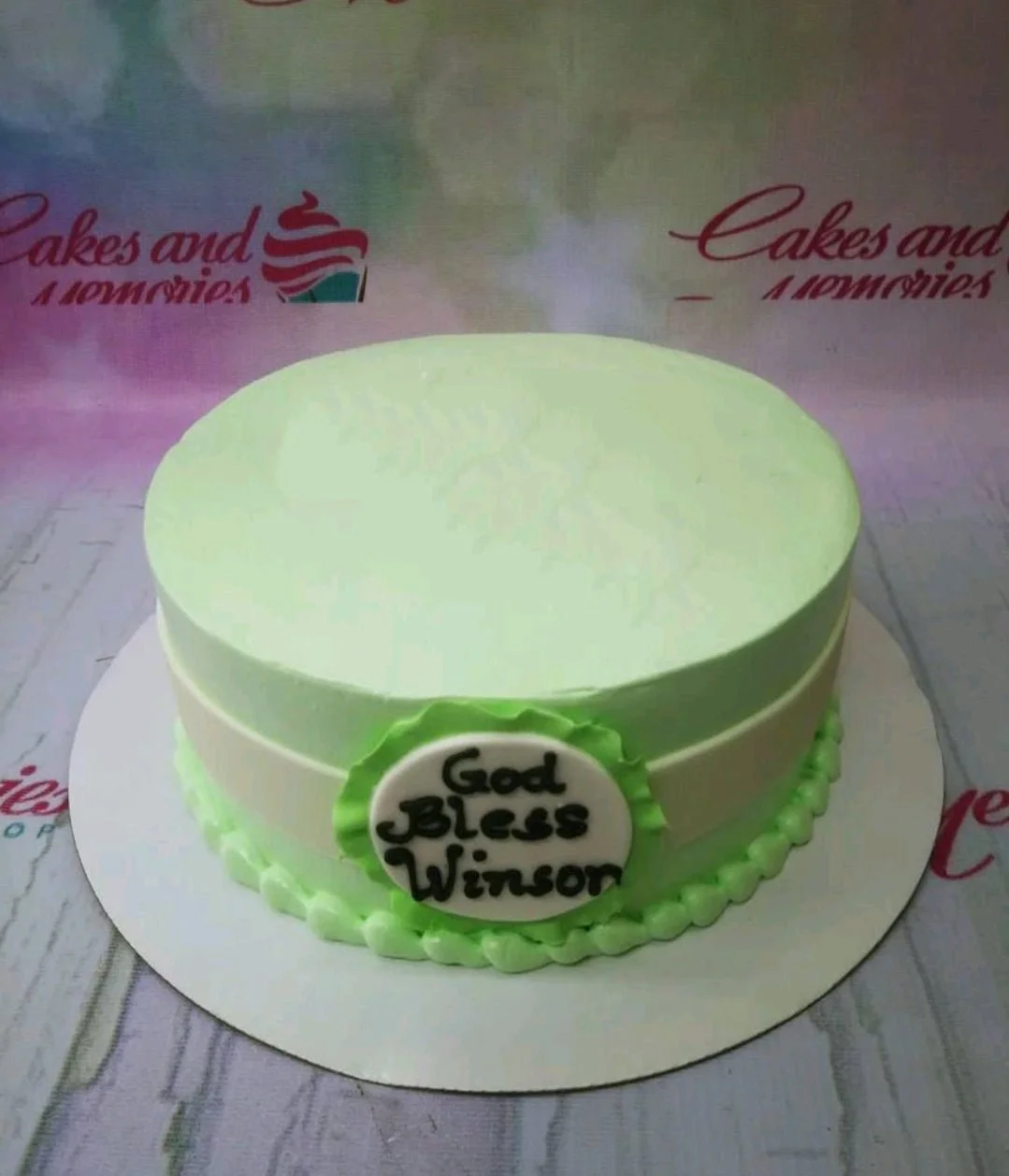 Minimalist Green Mint Christening Cake Light green minimalist cake with a white fondant plaque and black icing message God Bless Winson.