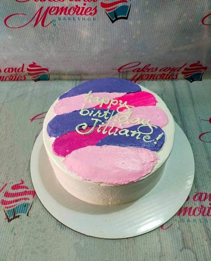 A minimalist white bento-style cake with artistic purple and pink palette knife icing strokes and a Happy Birthday message. A minimalist white bento-style cake with artistic purple and pink palette knife icing strokes and a Happy Birthday message.