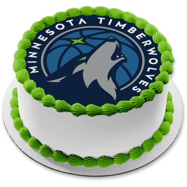 White round cake with green icing borders and a large Minnesota Timberwolves logo printout on top. White round cake with green icing borders and a large Minnesota Timberwolves logo printout on top.