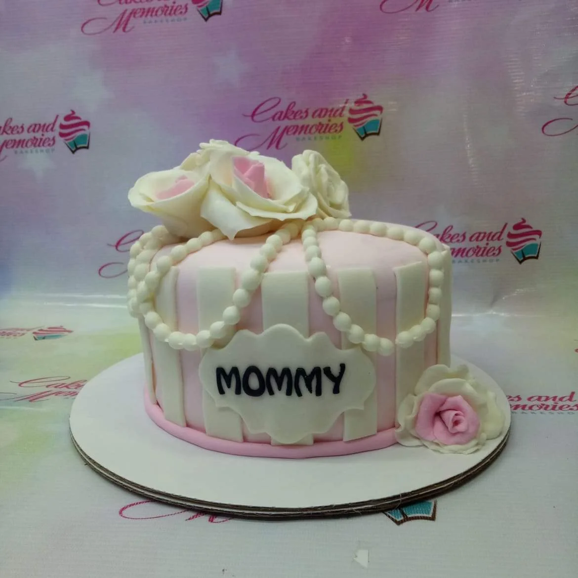 Mommy Floral Cake A pink and white striped 1 Tier Fondant cake for Mommy, with large white and pink sugar roses and edible pearl drapes.