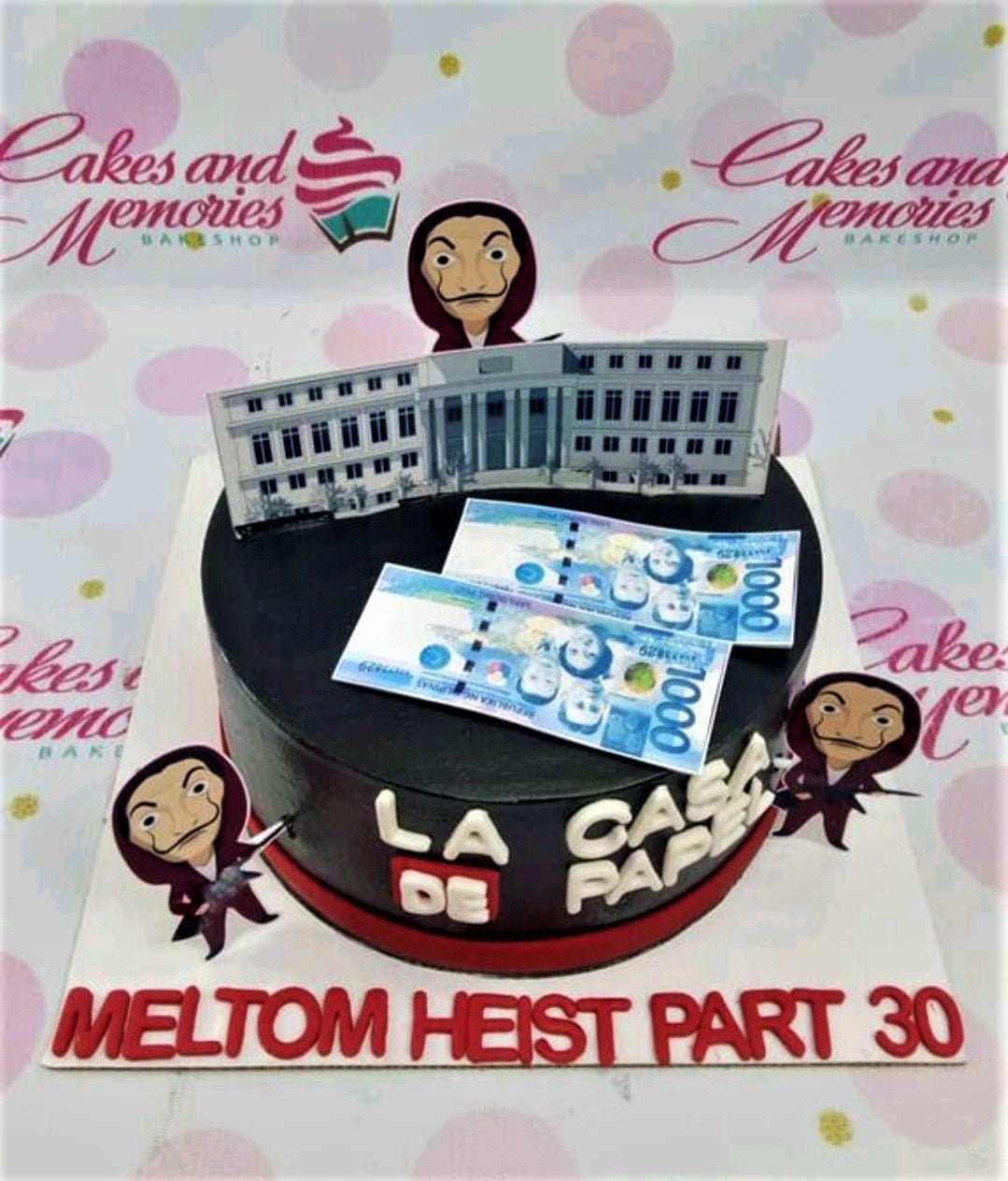 Black Money Heist themed cake with Dali mask printouts, building backdrop, and Philippine peso bill toppers. Black Money Heist themed cake with Dali mask printouts, building backdrop, and Philippine peso bill toppers.