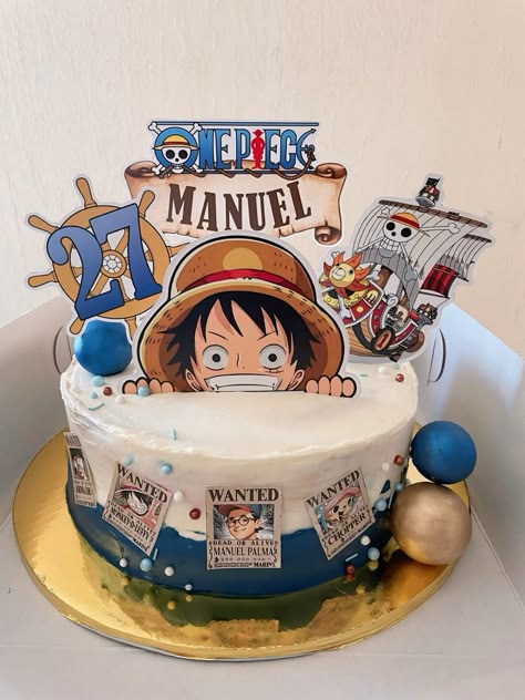 One Piece themed birthday cake with Luffy, Thousand Sunny, and wanted posters on white and blue icing. One Piece themed birthday cake with Luffy, Thousand Sunny, and wanted posters on white and blue icing.