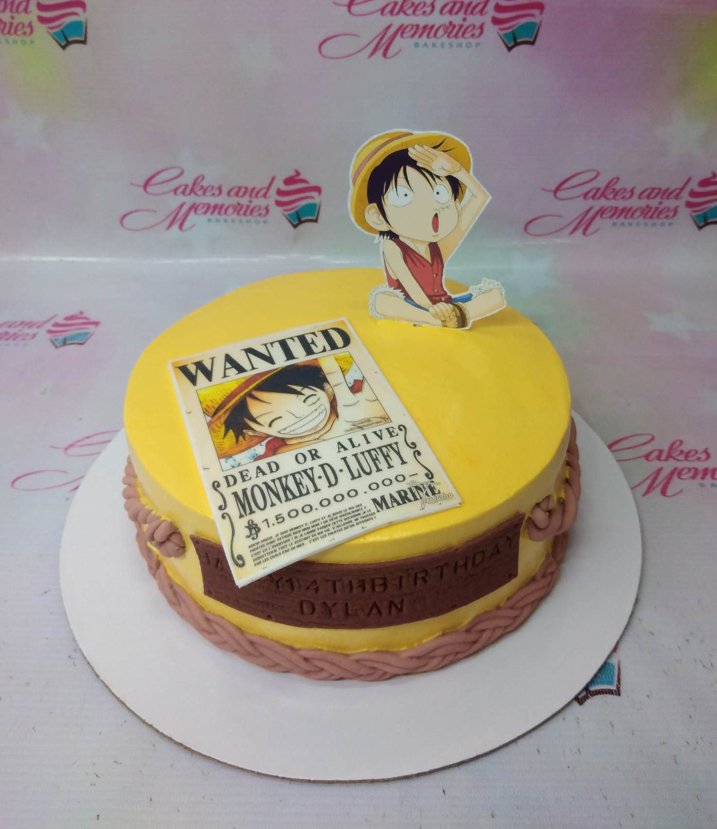 Yellow One Piece themed birthday cake with Monkey D. Luffy printout toppers and a brown fondant message banner. Yellow One Piece themed birthday cake with Monkey D. Luffy printout toppers and a brown fondant message banner.
