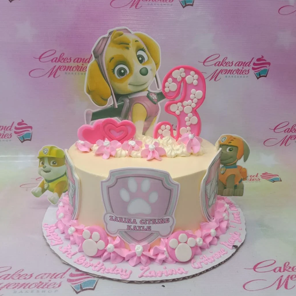 Paw Patrol-Inspired Skye Ivory Birthday Cake A cream and pink 1-tier cake themed around Paw Patrol Skye, featuring Skye, a number three, pink rosettes, and paw prints.