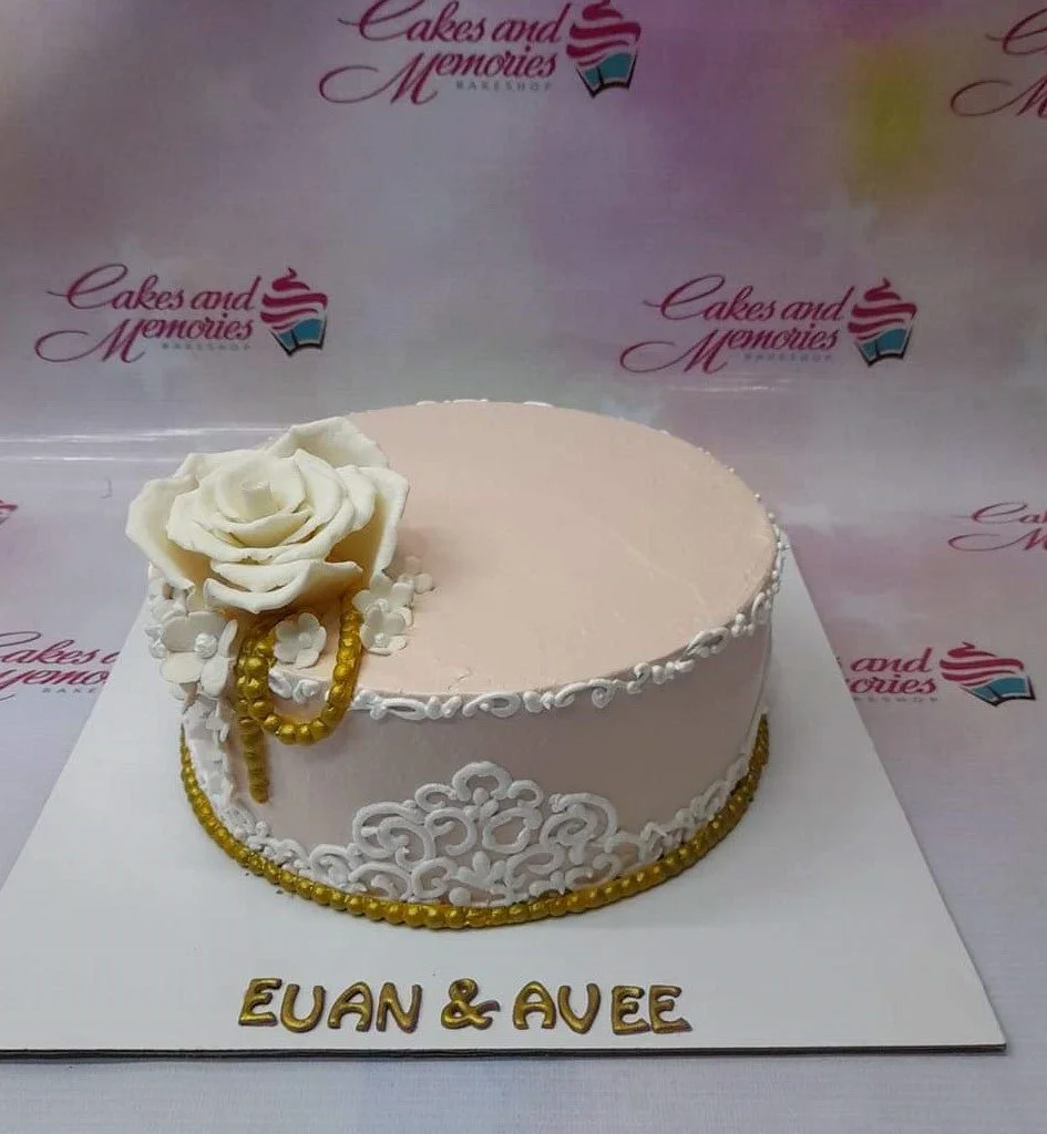Peach Rose Floral Cake A peach 1-tier cake themed Peach Rose, with a large white gumpaste rose, gold pearl accents, and white icing filigree.