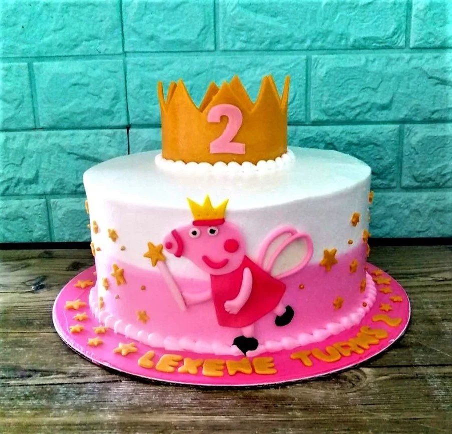 Peppa Pig fairy themed birthday cake with a large gold crown topper and pink ombre icing.